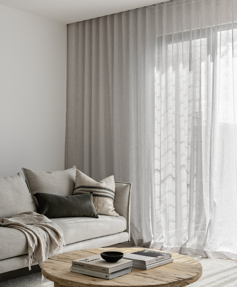 Three Gables Sheer linen curtains soften this exquisite monochromatic home