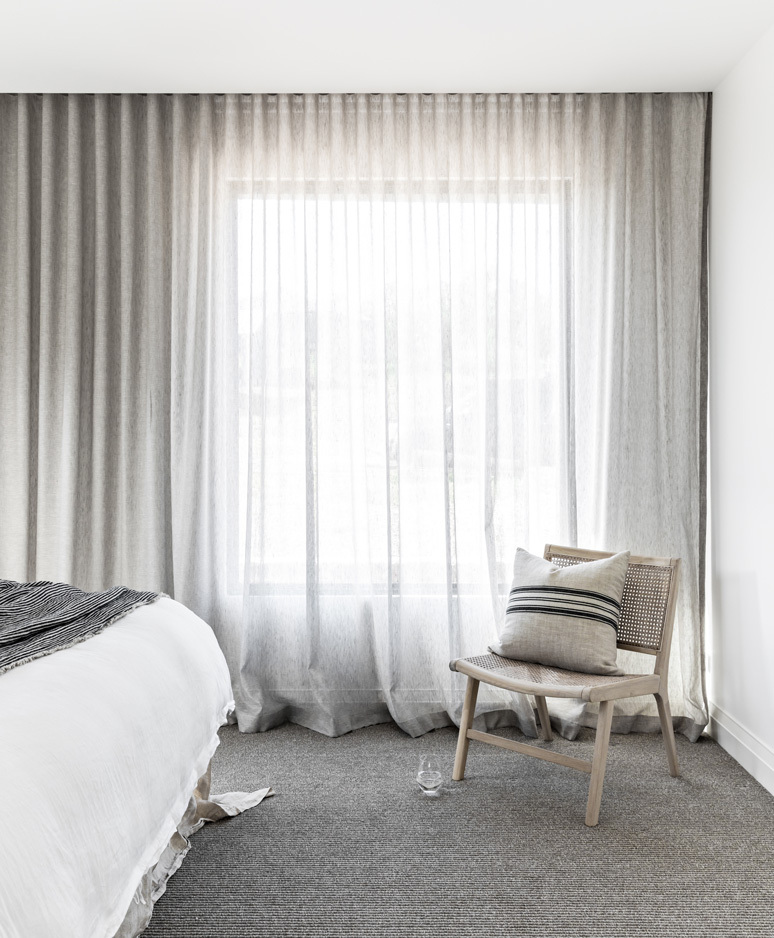 Three Gables Sheer linen curtains soften this exquisite monochromatic home